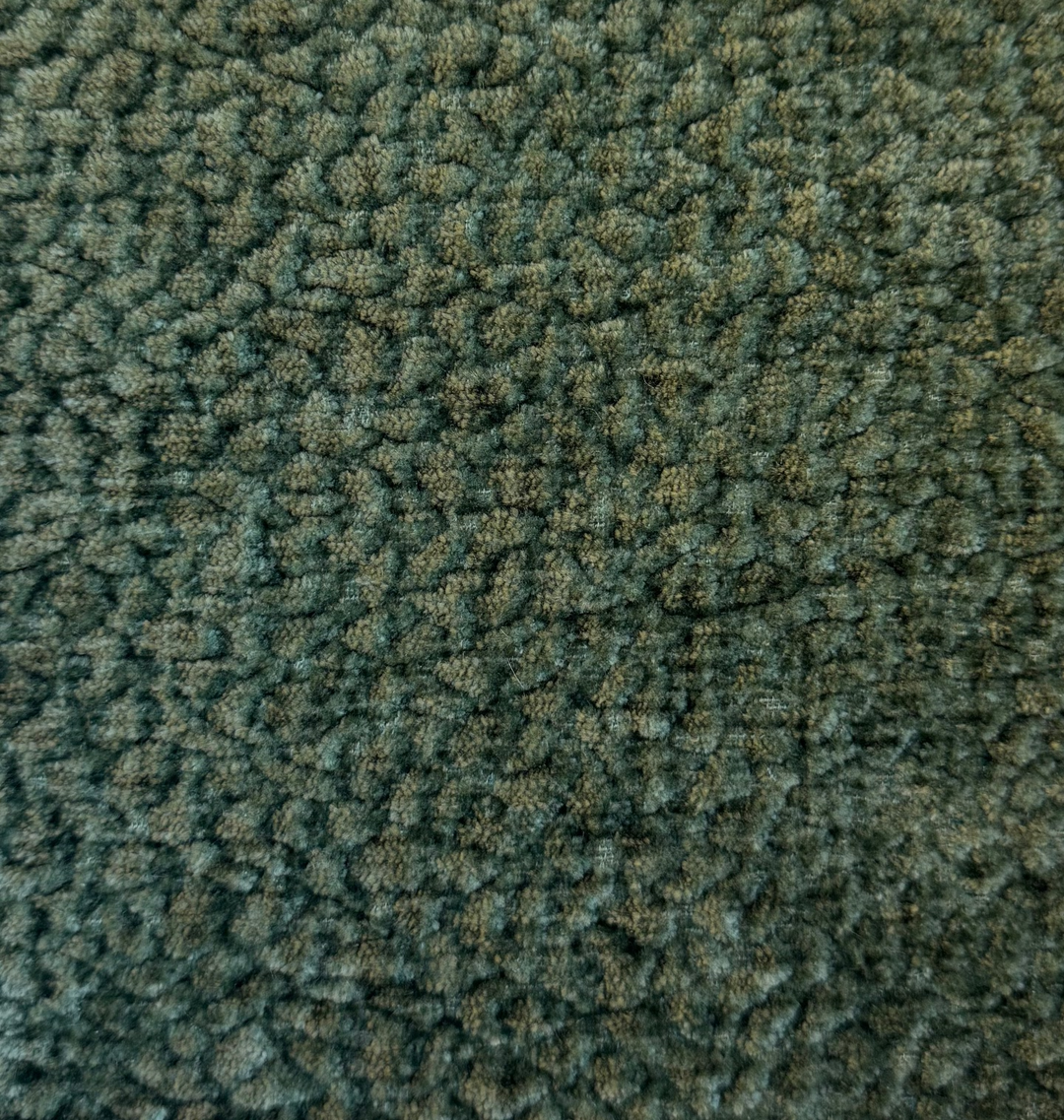 Square piece of green textured fabric on a white background