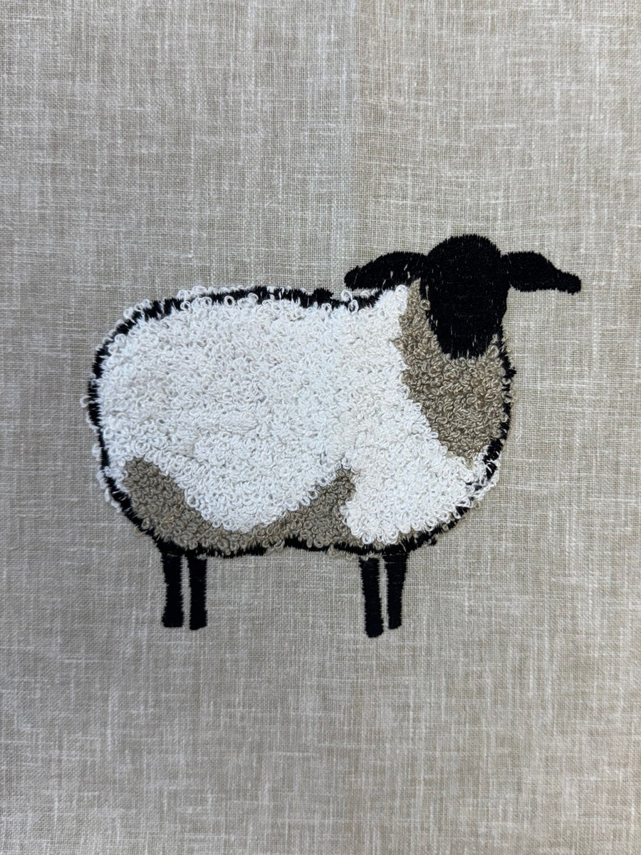 Embroidered sheep design on fabric
