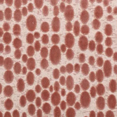 A close-up of a fabric pattern featuring a dense, organic dalmatian-like spot print in a muted terracotta red on a warm off-white textured background.