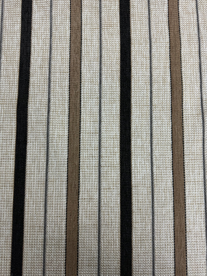 A fabric with a striped pattern featuring colors black, brown, white, and beige.