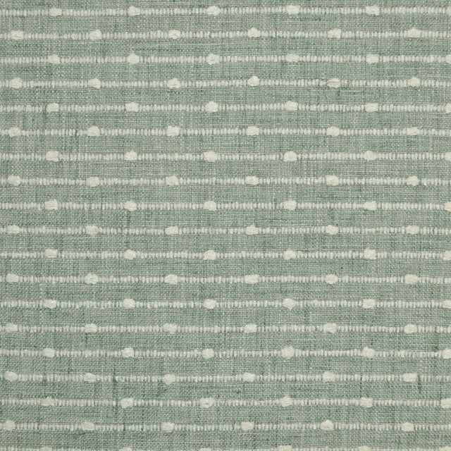 Textured green fabric pattern with small white dots