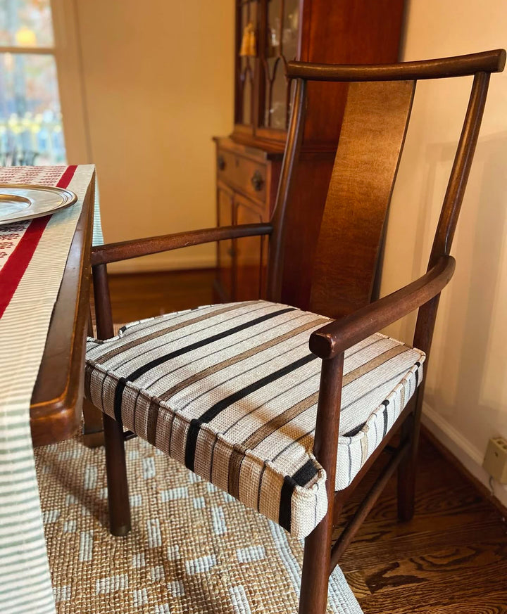 striped seat cushion on wooden chair