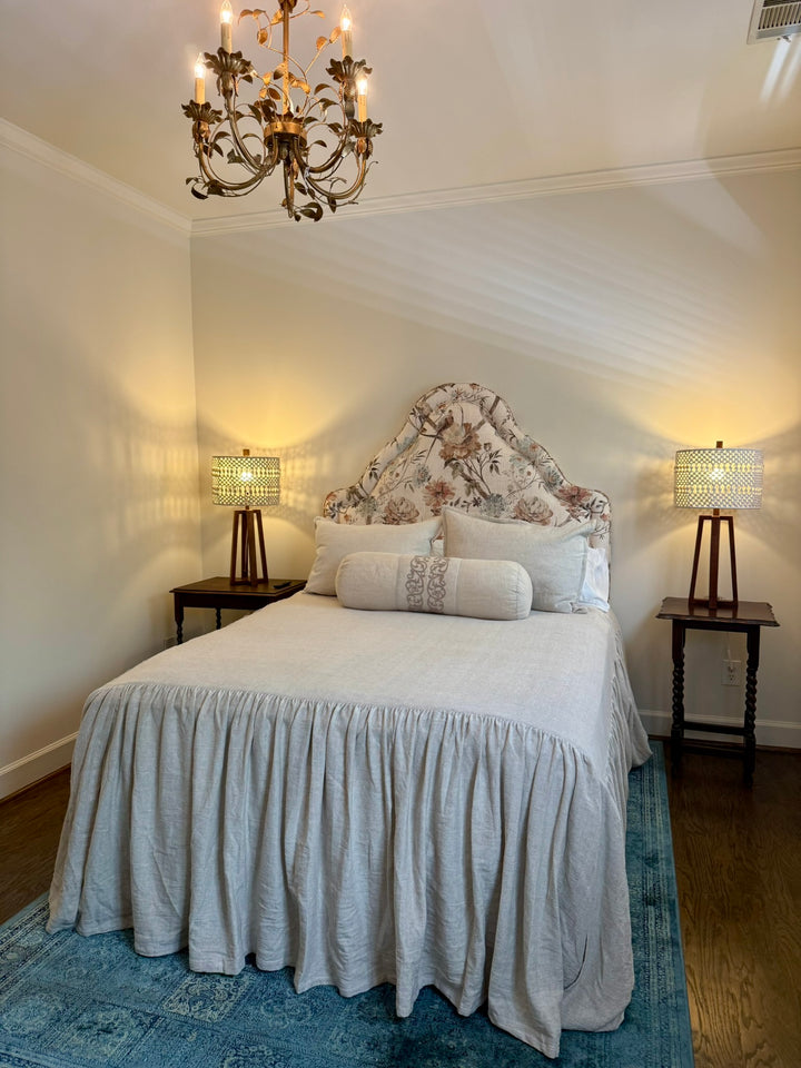 floral fabric headboard with beige bedding