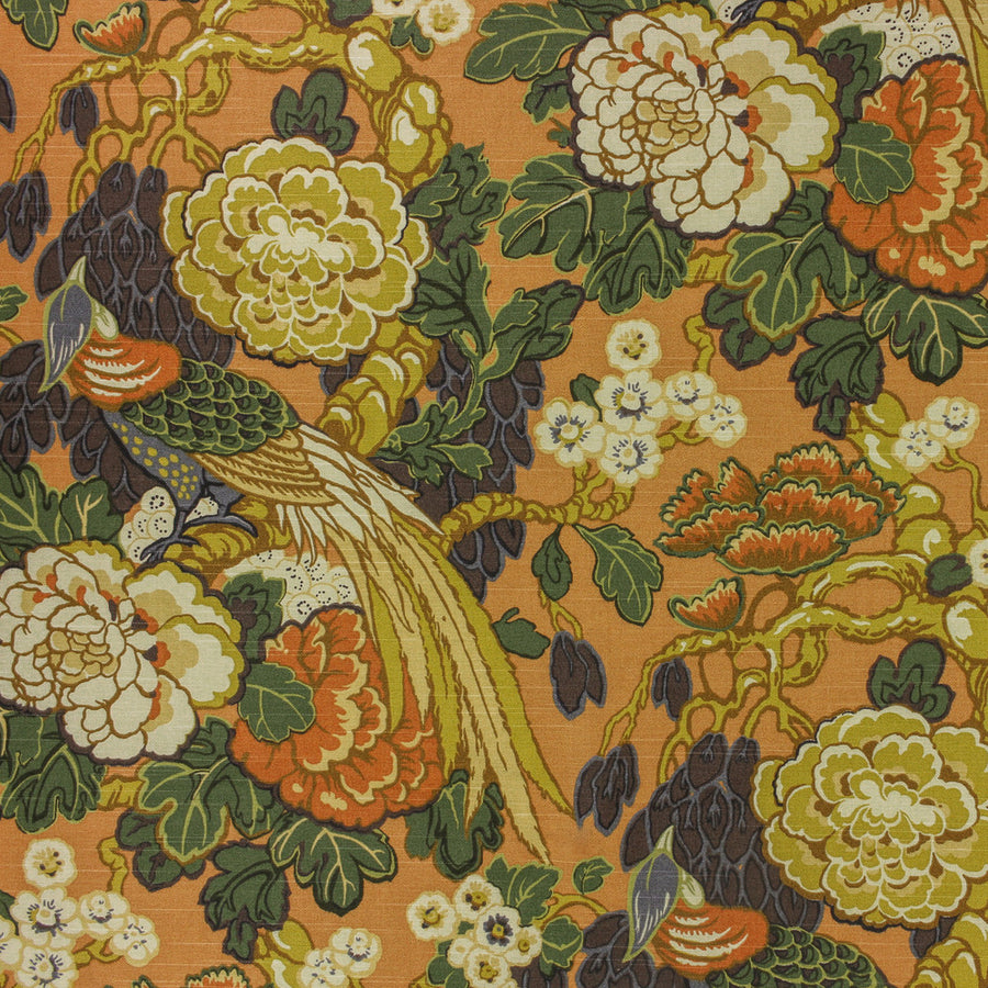 Close-up of a floral and bird pattern on fabric with an orange background