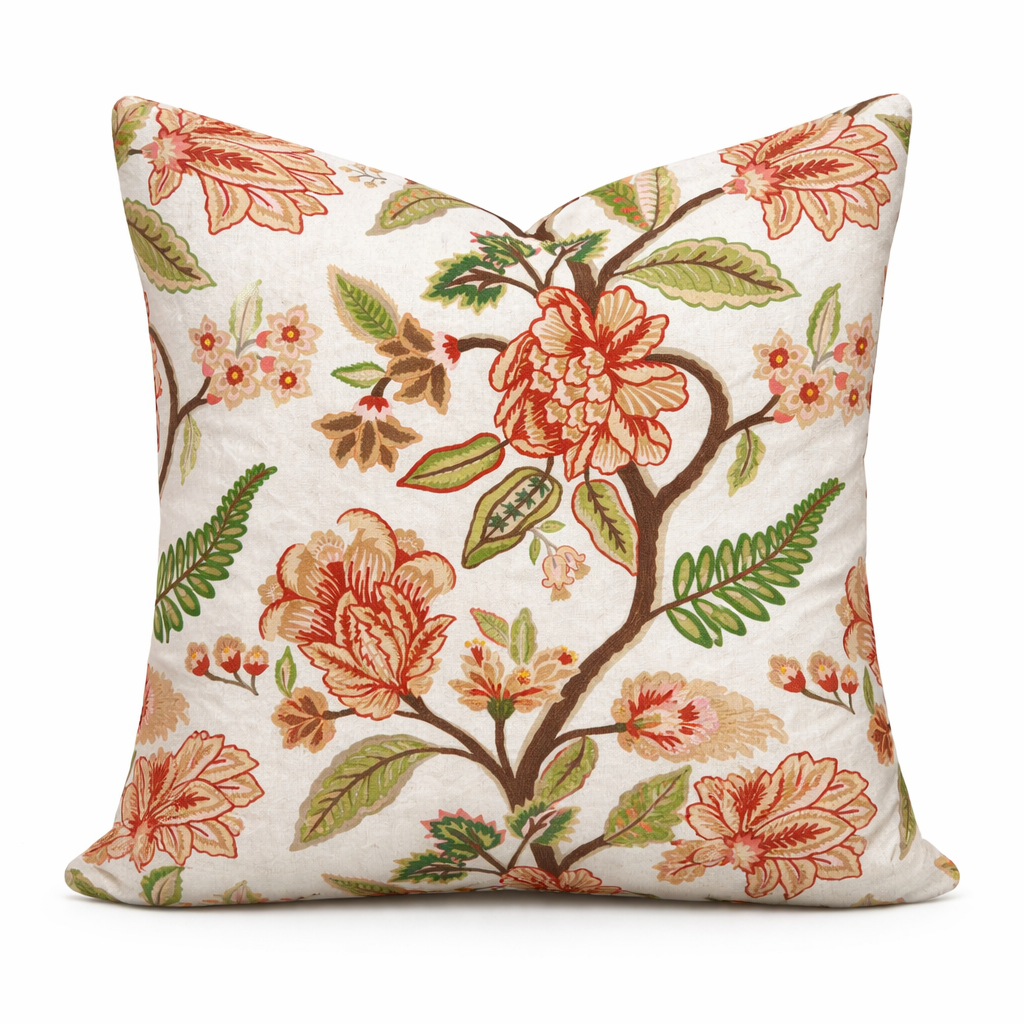 Floral and leaf patterned pillow on a white background