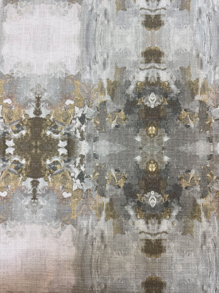 A fabric featuring an abstract geometric pattern with grays, creams, and light blue colors.