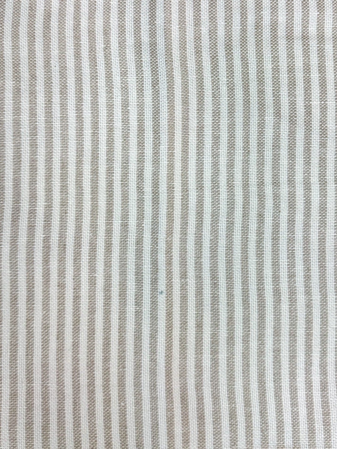 Textured fabric with thin brown stripes on a white background