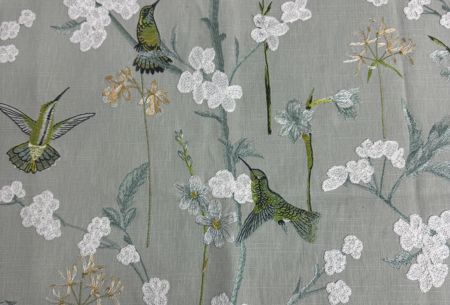 Fabric with bird and floral pattern on a gray background