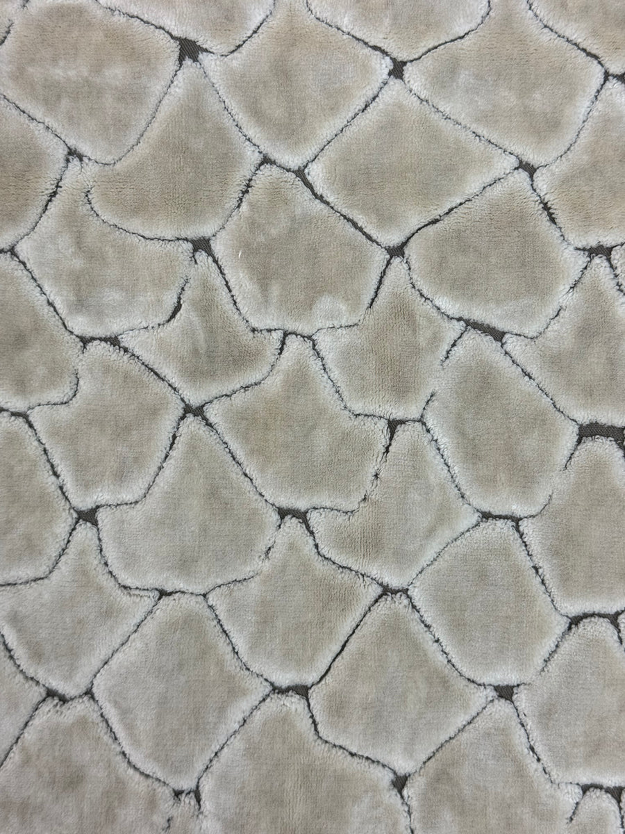 Close-up of textured beige fabric with diamond pattern