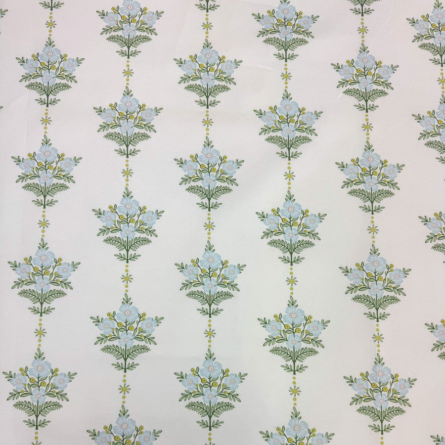 Floral pattern with blue flowers and green leaves on a light background