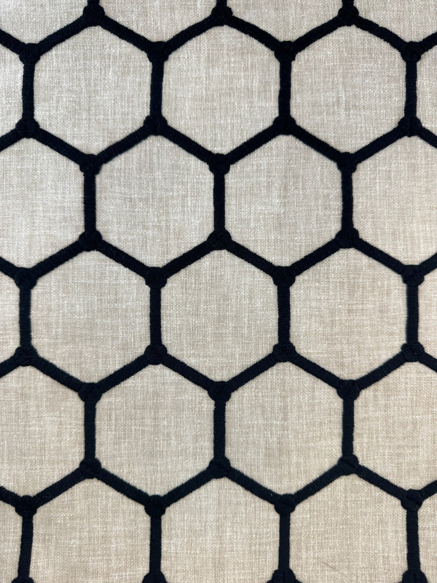 Hexagonal pattern fabric texture with black lines on a beige background