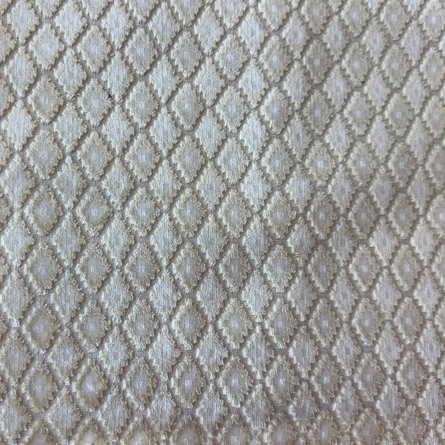 Textured gray fabric swatch held 
