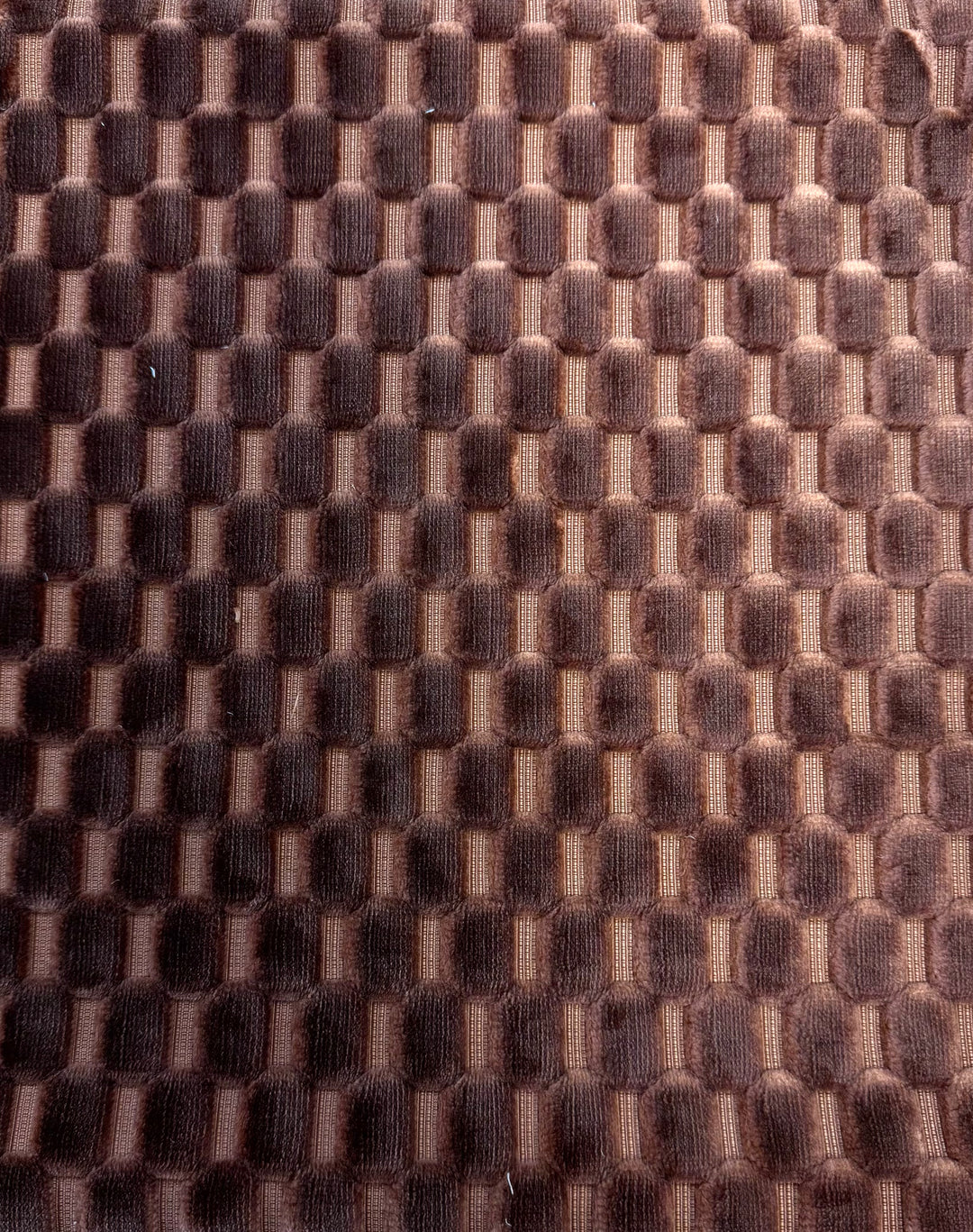 Close-up of brown textured fabric with a grid pattern