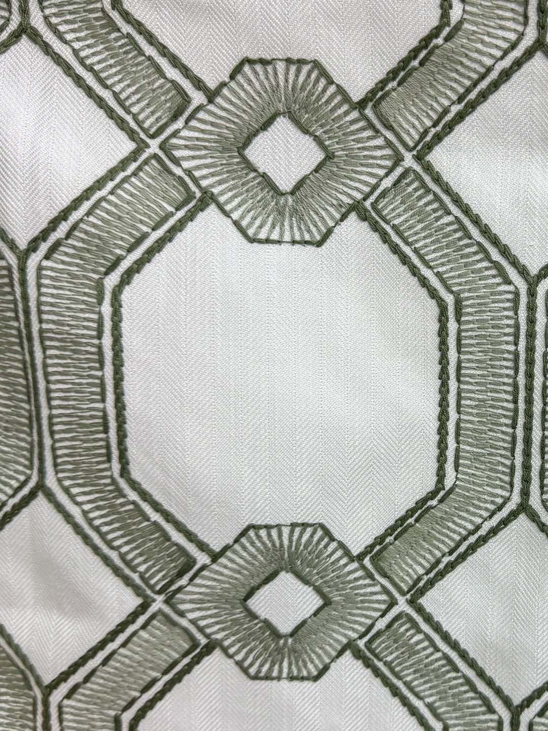 green embroidered and geometric fabric by the yard