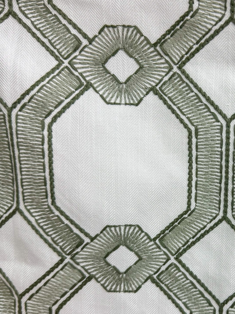 green embroidered and geometric fabric by the yard