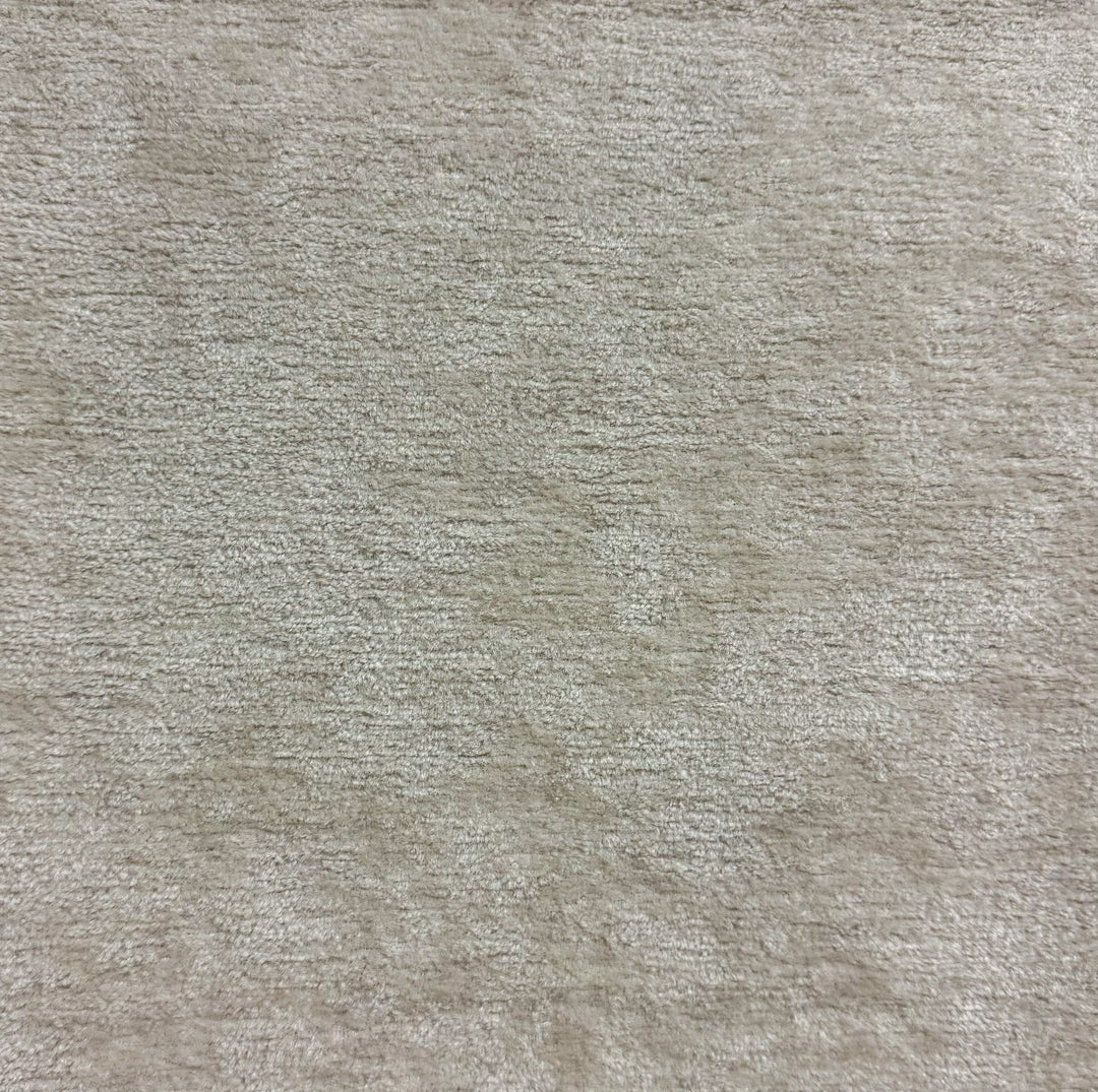 Close-up of a textured beige fabric surface