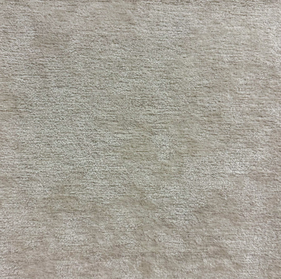 Close-up of a textured beige fabric surface
