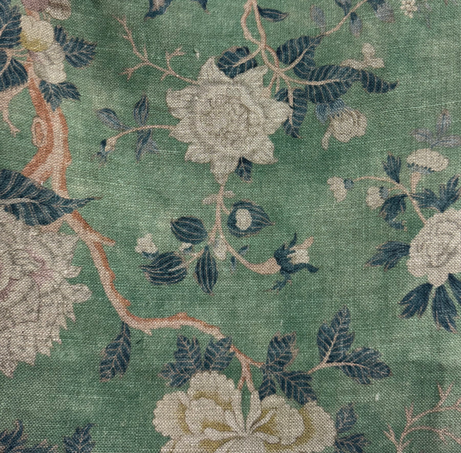 Close-up of floral fabric pattern with green background