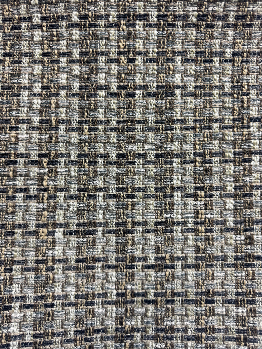 Textured fabric with a checkered pattern in black, white, and brown.