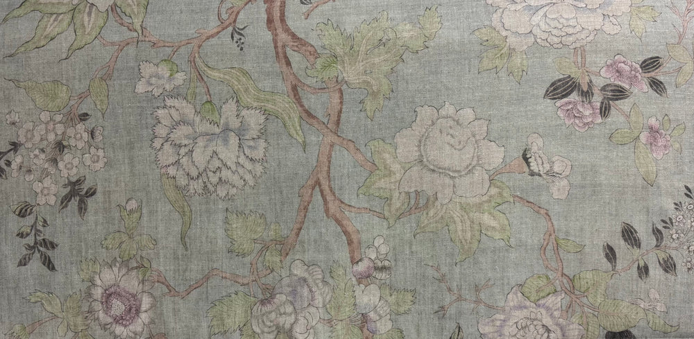 Floral patterned fabric with flowers and leaves on a light green background