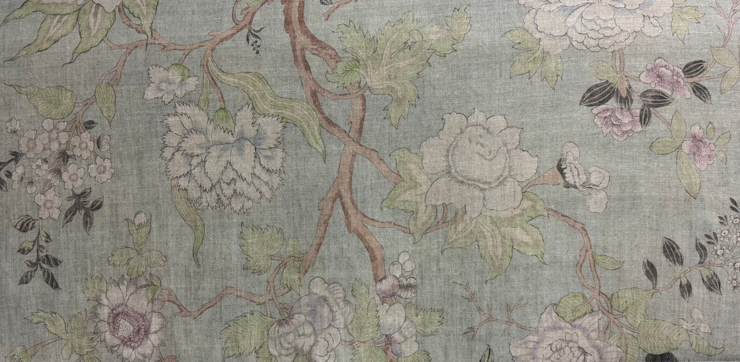 Floral patterned fabric with flowers and leaves on a light green background