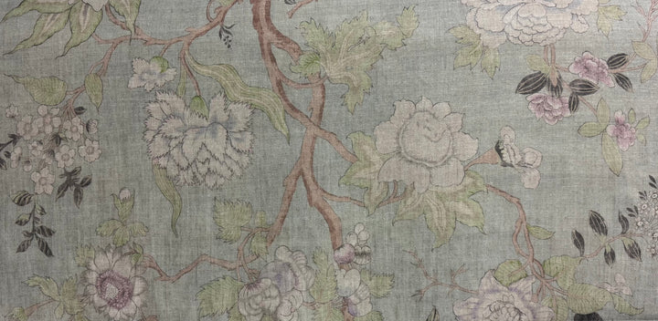 Floral patterned fabric with flowers and leaves on a light green background