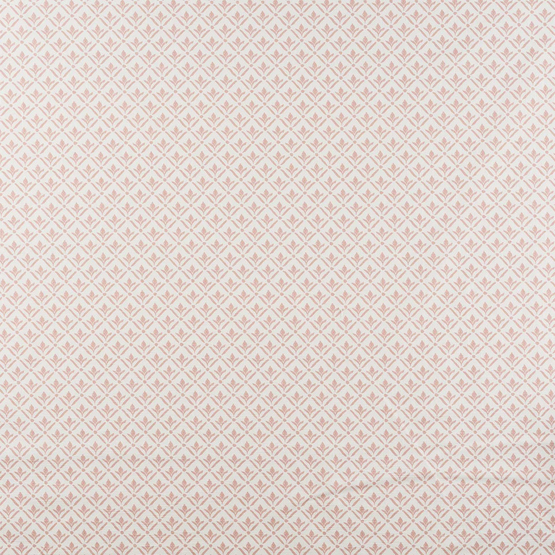 A close-up of a repeating fabric or wallpaper pattern in pale blush pink and off-white, showing a small diamond-and-floral motif across the full frame.