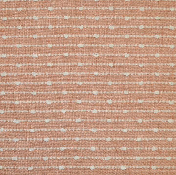 Textured fabric pattern with small white lines on a pink background