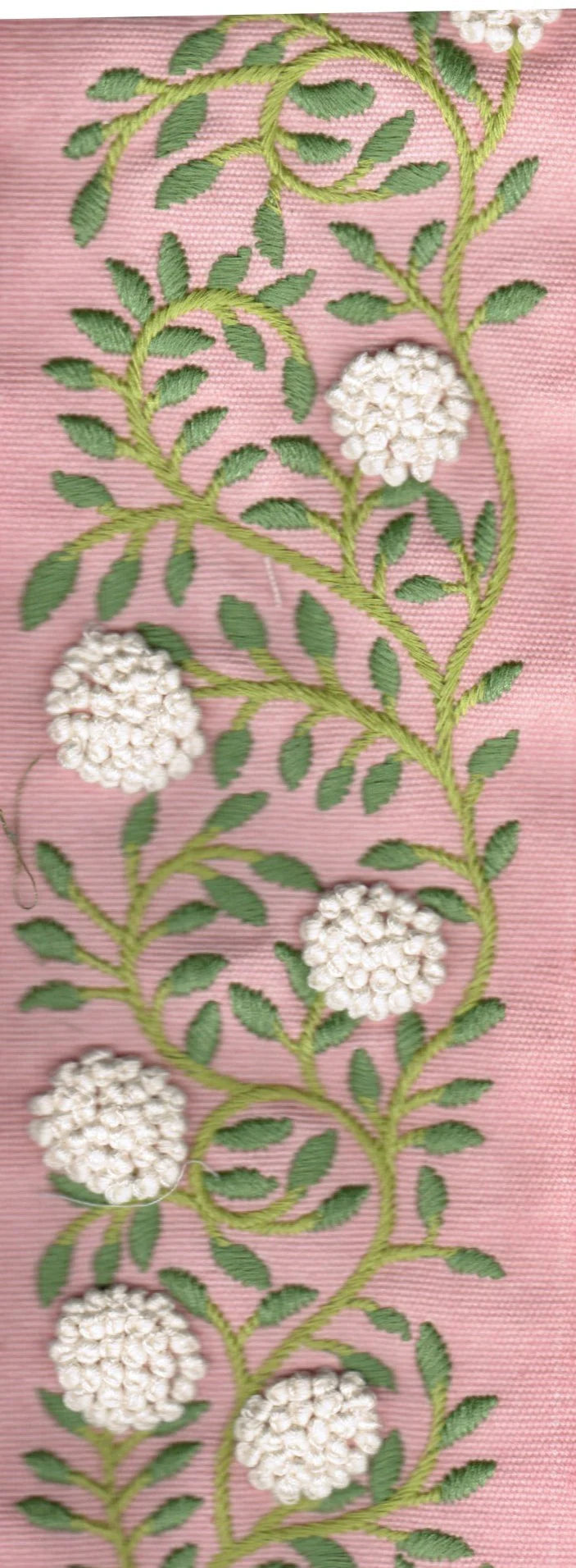 Embroidered floral design on a pink background