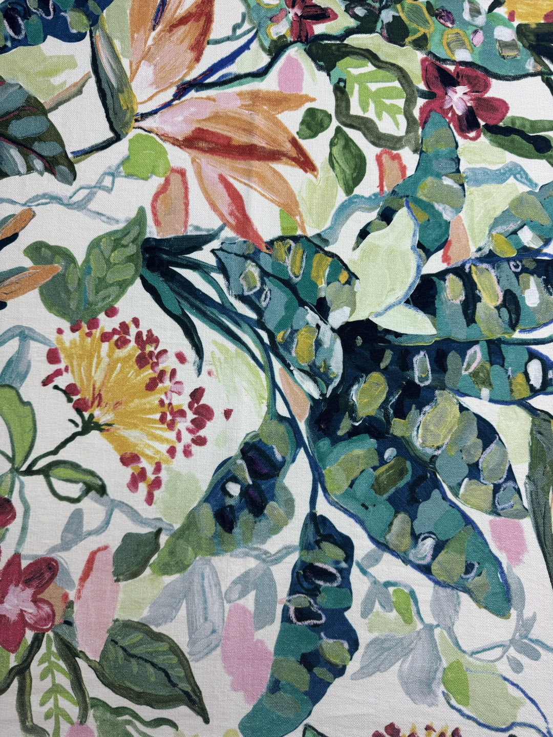 Close-up of a colorful floral and leaf pattern on fabric.