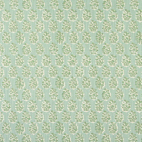 Patterned fabric with green trees on a light blue background