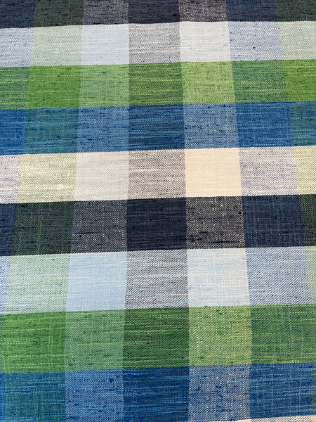 Close-up of fabric with a striped pattern featuring multiple colors including blue, green, and beige.